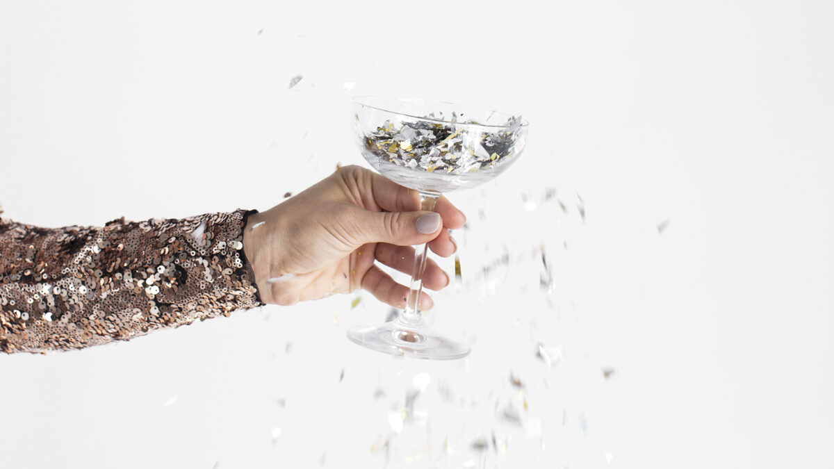 Woman's hand holding a coupe of confetti.